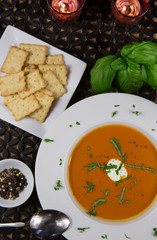 Tomato Bisque Served in a Bowl with Basil and Sour Cream Garnish