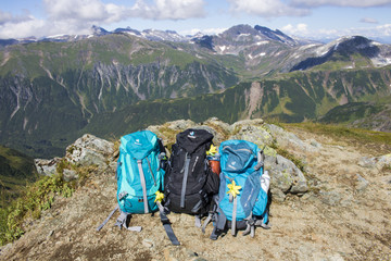 Three hiking backpacks on the side of a mountain