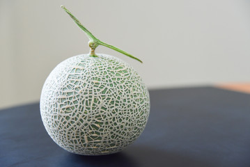 Green Cantaloupe Melon Isolated on Wooden Table