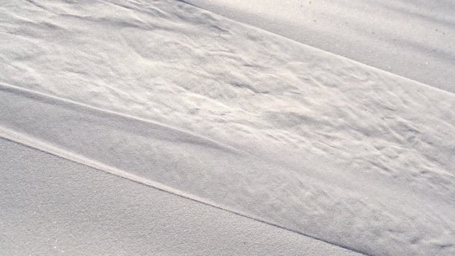 Water trickles down smooth white sand, Dubai