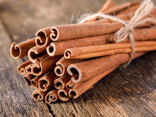 Cinnamon on table wooden background.