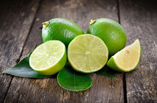 Fresh ripe limes on wooden table.