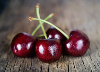 Fresh cherry on wooden background.