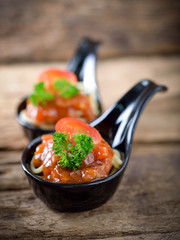 Spaghetti with tomato sauce on wooden table.