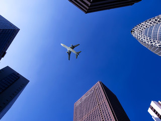 Obraz premium airplane flying over buildings