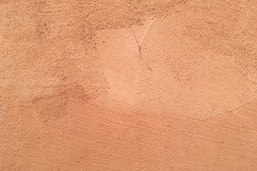 Closeup on Light brown painted on exterior rough stucco wall Texture Italian style Background.