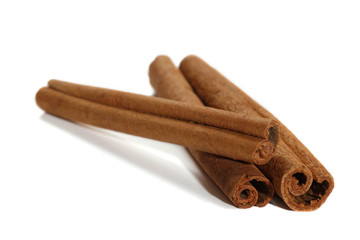 Closeup on cinnamon sticks on white background