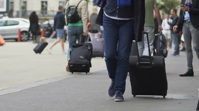 Tourist with suitcase leaving airport, people traveling, slow-motion video