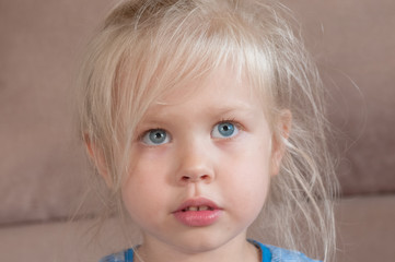 Portrait of a little girl with blue eyes and blond hair
