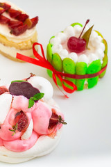 Small cakes with different stuffing. White background. Close-up. Top view