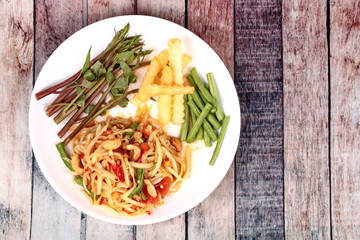 Thai popular recipe, Spicy and sour mixed vegetable salad with papaya roll call Som Tum in Thai topped french fried strick ,lentils and morning glory.