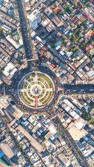 Fototapeta premium Aerial view, Road roundabout, Expressway with car lots in the city in Thailand. beautiful Street , downtown, cityscape, Top view. Background
