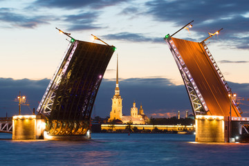 Fototapeta na wymiar Peter and Paul Cathedral in the alignment of the diluted Palace Bridge on a white night. Saint-Petersburg, Russia