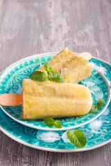 Green popsicles on blue plate