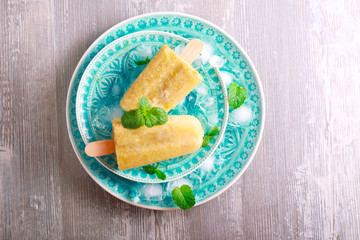 Green popsicles on blue plate