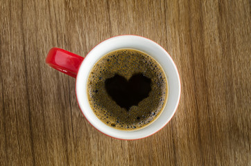 Cup Of Coffee And Heart Shape On Wood Table.