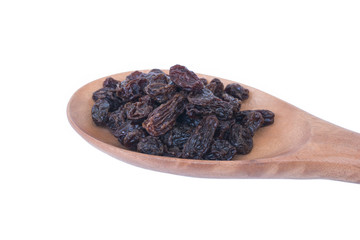 Raisins (Sultanas) in spoon wood isolated on white