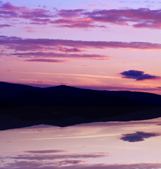 Beautiful pink, purple sky above lake sunrise in morning