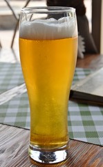 A glass of beer with foam