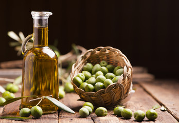 Olive oil and olives on wooden rustic table