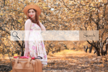 search bar on the background blurred photo of a girl with leather suitcase for travel