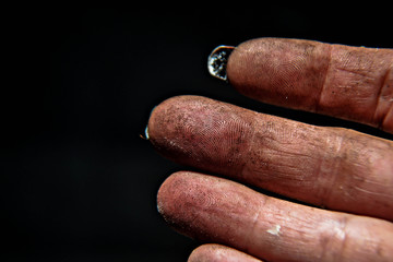Human fingers whit fingertips at the black background