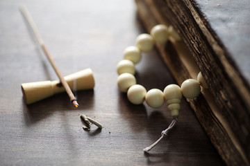 Beads and Incense on wooden table