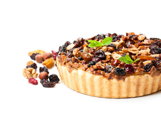 Delicious  tart with dried berries and nuts isolated on white