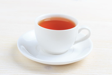 Cup with green tea on a saucer on a white background