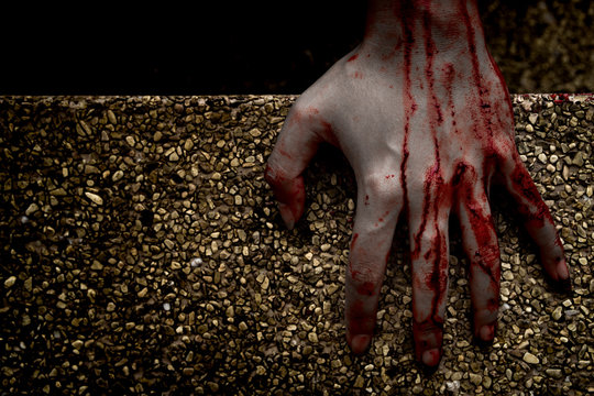 Hand zombie death with blood touching stair on nightmare darkness background, horror halloween festival concept