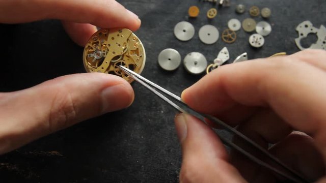 Watchmaker is repearing a mechanical watches