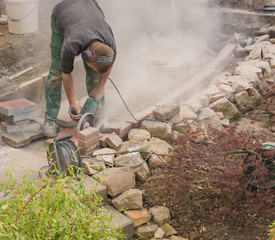 Craftsman works with an electric grinding machine