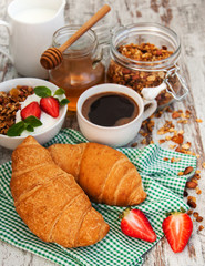 Croissant, coffee, granola  and strawberry