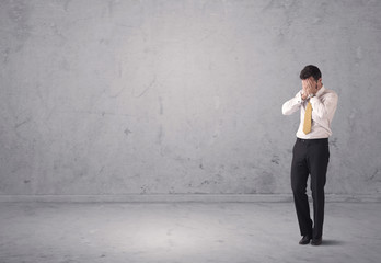 Young businessman standing confused
