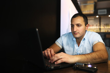 Armenian handsome man working behind laptop