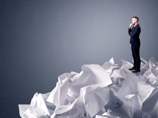 Businessman standing on crumpled paper