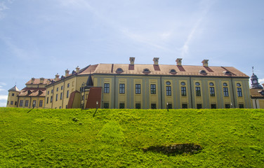Fototapeta na wymiar Building of an ancient castle standing on green hills