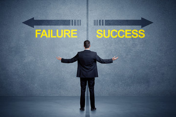 Businessman standing in front of success and failure arrow concept