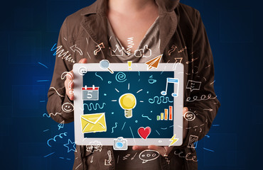 Woman holding tablet with applications