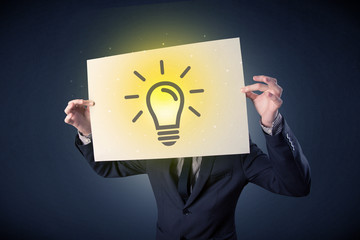Businessman holding paper with lightbulb