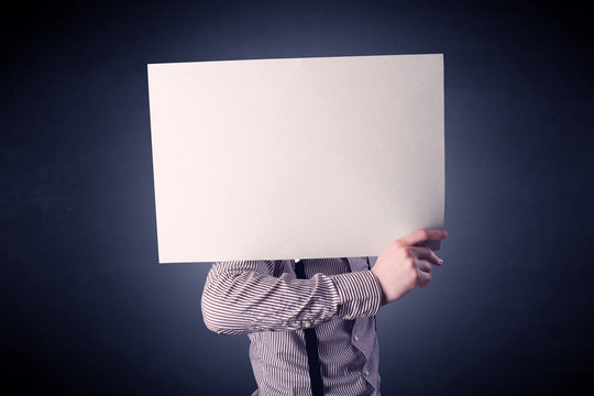 Businessman holding blank paper