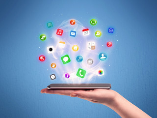 Hand holding tablet phone with app icons