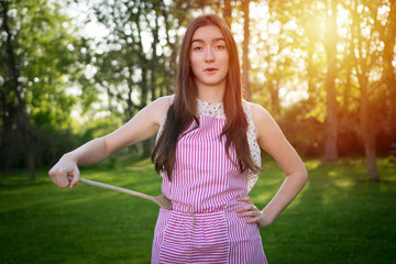 Young housewife with spoon in a natural environment