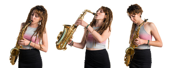 Girl with dreadlocks playing the saxophone
