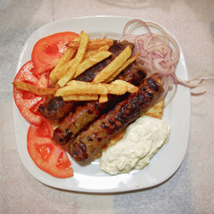 Traditional Kebab plate, with roasted meat steaks,fries tomato and tzatziki sauce