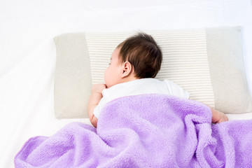 Portrait of sleeping baby  lying on a bed