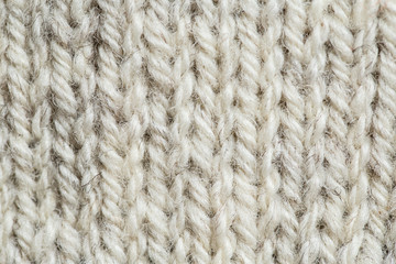 A beautiful closeup of a hand knitted warm and soft wool pattern. Soft socks or scarf of natural wool. Colorful pattern.