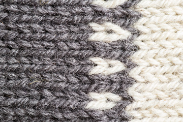 A beautiful closeup of a hand knitted warm and soft wool pattern. Soft socks or scarf of natural wool. Colorful pattern.