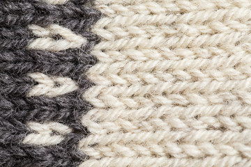 A beautiful closeup of a hand knitted warm and soft wool pattern. Soft socks or scarf of natural wool. Colorful pattern.