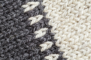 A beautiful closeup of a hand knitted warm and soft wool pattern. Soft socks or scarf of natural wool. Colorful pattern.